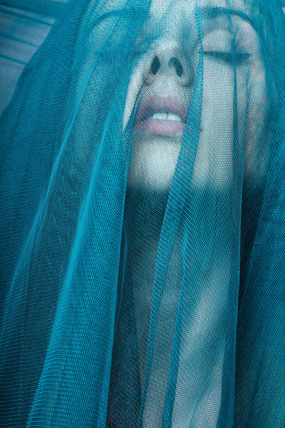 Young woman, blue color material - Fotoğraf, Görsel