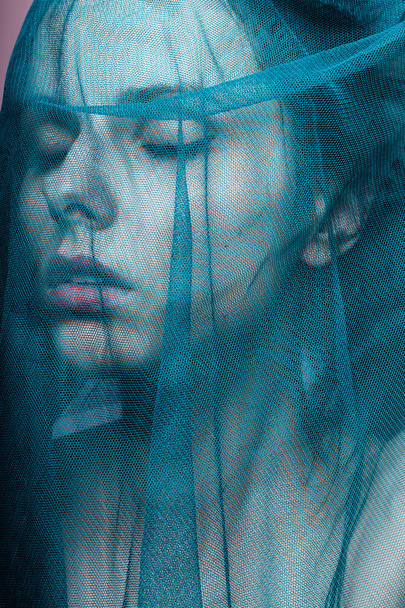 Young woman, blue color material - Foto, Imagen