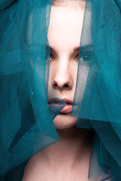Young woman, blue color material - Φωτογραφία, εικόνα