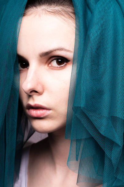 Young woman, blue color material - Фото, изображение