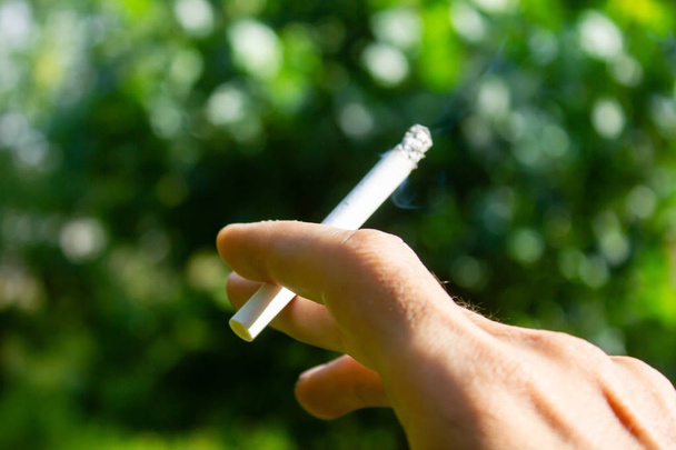 young guy holding a cigarette - Фото, зображення