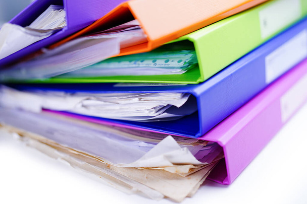 File Folder Binder stack of multi color on table in office. - Photo, Image