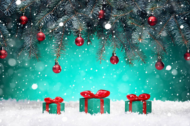 Рождественская открытка - подарки и игрушки в снегу под новогодней елкой
 - Фото, изображение