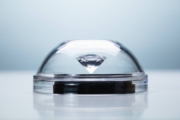 Diamond Protected With Transparent Dome Over Gray Background - Foto, afbeelding