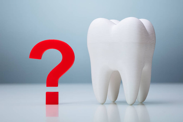 Question Mark Near White Tooth Over Gray Background - Φωτογραφία, εικόνα