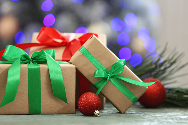 Christmas gifts on table against blurred background - Foto, Imagen