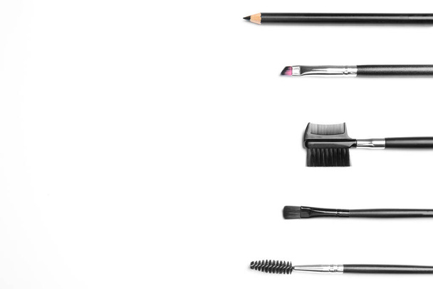 Set of professional eyebrow tools on white background, top view - 写真・画像