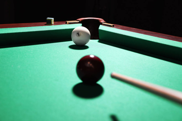 Striking red ball into billiard table pocket - Fotó, kép