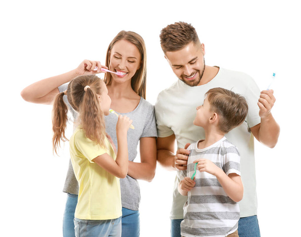 Portrait of family brushing teeth on white background - Foto, afbeelding