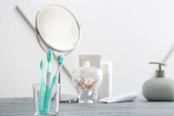 Toothbrushes on table in bathroom - Foto, Imagen