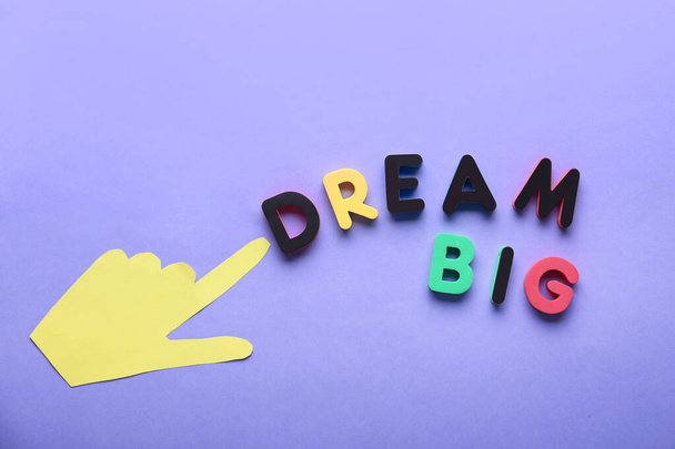 Words BIG DREAM with paper hand on color background - 写真・画像