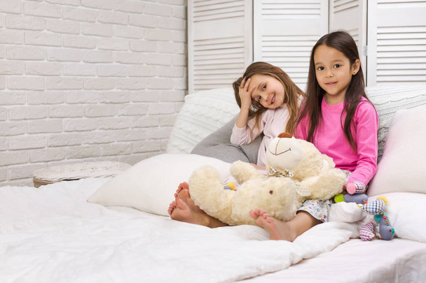 two happy cute children girls playing in the bedroom. - Photo, image