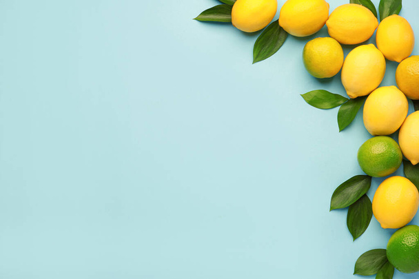 Ripe lemons and limes on color background - 写真・画像