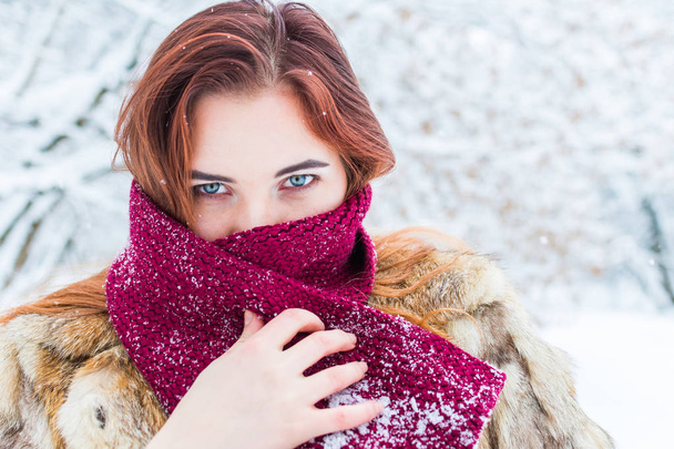 young beautiful woman wrapped in a scarf in winter in outdoors - Photo, Image