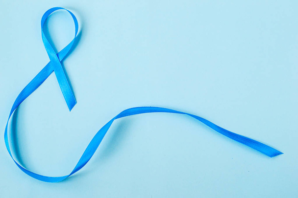  Light blue ribbon on blue background, prostate cancer awareness, men's health awareness  blue November. - Fotoğraf, Görsel