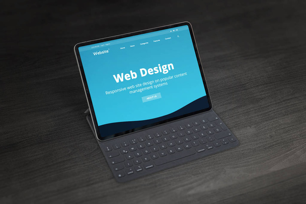 Web design studio promo website op tablet met toetsenbord op bureau. Responsive web design promotie concept. - Foto, afbeelding