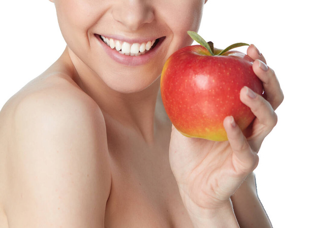Cute young lady holding red apple while isolated on white background - Φωτογραφία, εικόνα