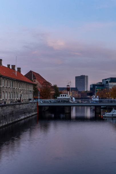 Sunset in Copenhagen on old canal with boats and houses reflecting in the calm water - 写真・画像