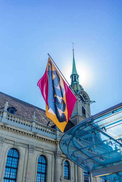 Flag of Canton Bern in Switzerland on the train station square - Photo, image