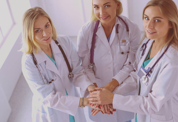 Doctors and nurses in a medical team stacking hands. - Fotografie, Obrázek