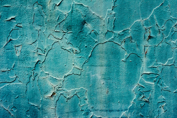 Metal texture with scratches and cracks which can be used as a background - Foto, afbeelding