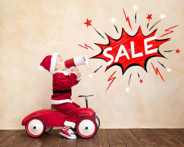 Happy child dressed Santa Claus costume playing at home - Foto, Imagen