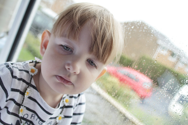 sad child in window - Photo, Image