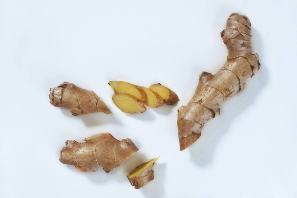 Top view of fresh ginger root sliced on white background.Healthy food and detox concept.Medical Products and Nutrition Ingredients.opy space for text. - Valokuva, kuva