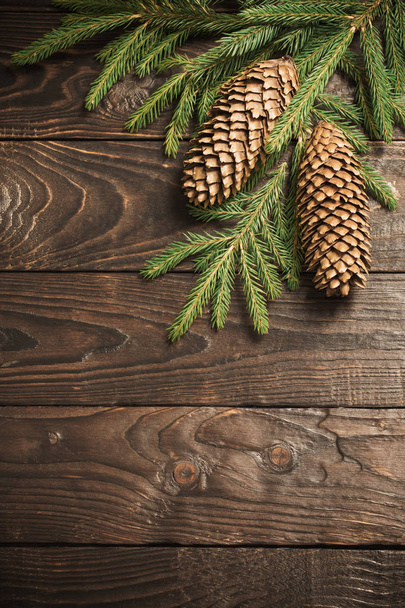 fir branches and cone on dark old wooden background  - Valokuva, kuva