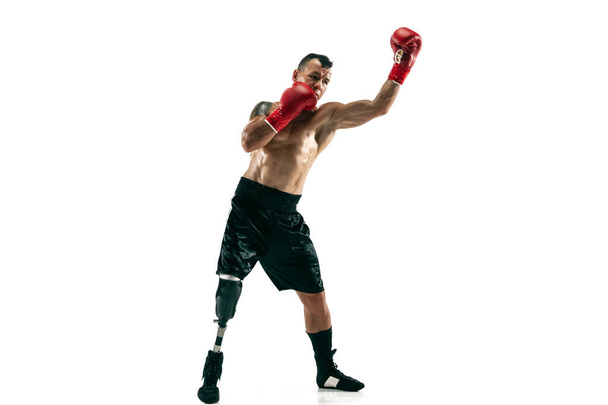 Full length portrait of muscular sportsman with prosthetic leg, copy space. Male boxer in red gloves. - Foto, Imagem