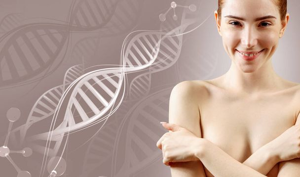 Νεαρή γυναίκα που καλύπτει το στήθος με τα χέρια μεταξύ των στελεχών DNA. - Φωτογραφία, εικόνα