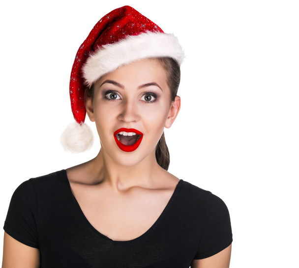 Νεαρή γυναίκα με εκφράζει σοκ στο καπέλο των Χριστουγέννων. - Φωτογραφία, εικόνα