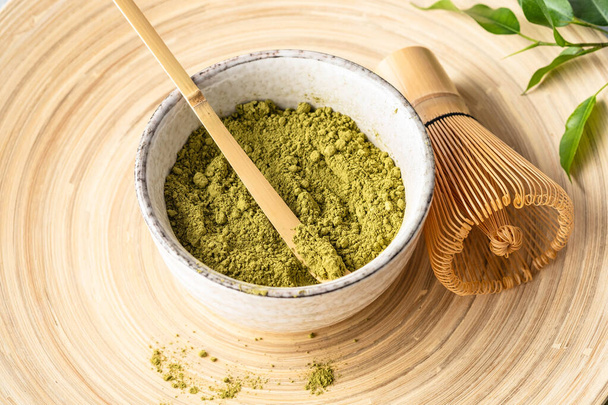 Japanese matcha green tea powder, a healthy natural product, antioxidant. Bamboo spoon and whisk. - Фото, зображення