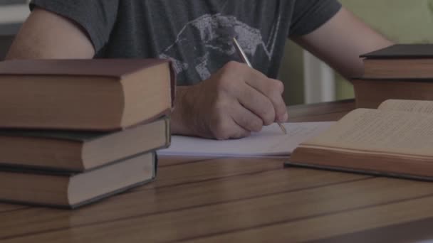Man writing with pen on the table. Slide shot. - Video