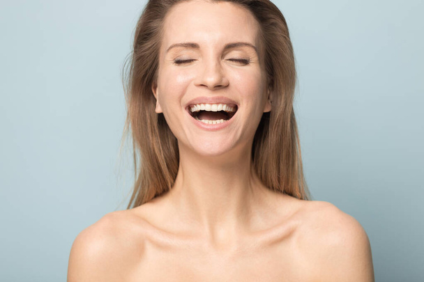 Happy young Caucasian woman laugh isolated in studio - Foto, Imagen