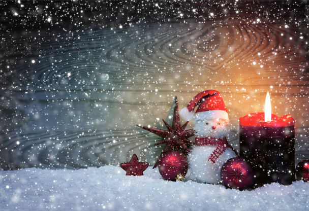 Christmas snowy background with fourth Advent candle and Snowman . - Photo, Image