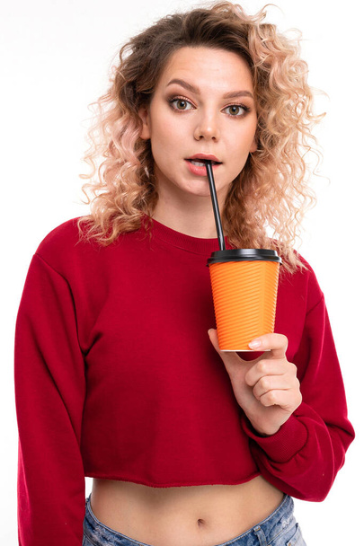 young beautiful blonde woman posing with coffee against white background - Foto, afbeelding