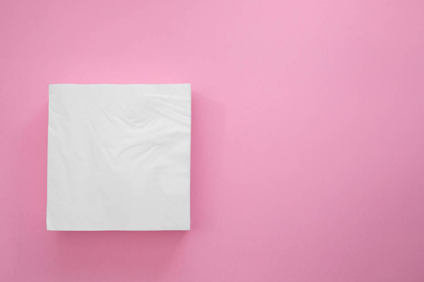 white paper napkins on pink background - Foto, imagen