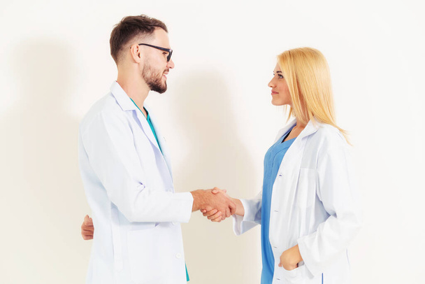 GP doctor shakes hand with surgical doctor. - Foto, immagini