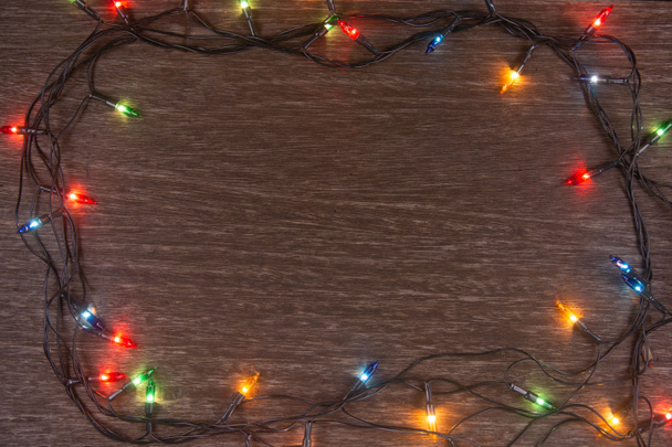Luzes de Natal no fundo de madeira escura. Feliz Natal e
  - Foto, Imagem