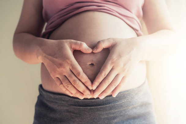 Happy pregnant woman and expecting baby at home. - Φωτογραφία, εικόνα
