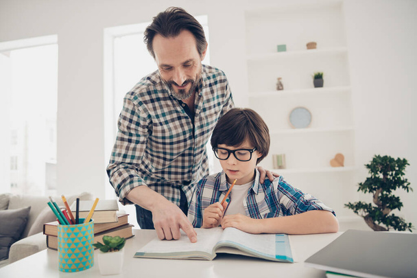 Doing home task with best daddy concept. Photo of two people positive patient intelligent daddy helping his offspring with homework preparation and tests - Fotoğraf, Görsel