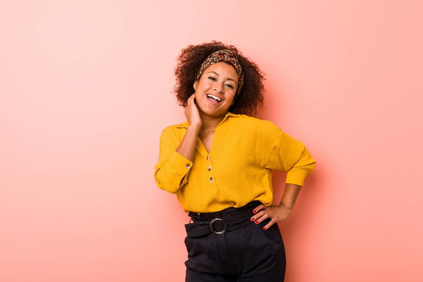 Young african american woman against a pink background - Photo, Image