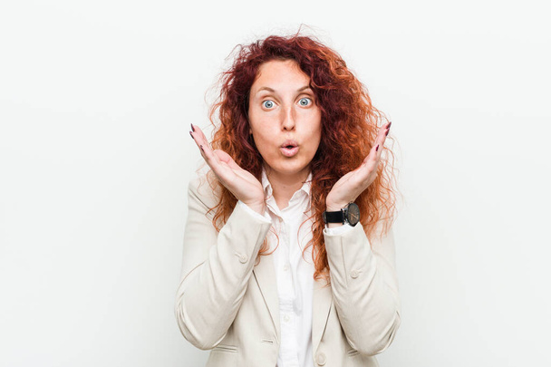 Young natural redhead business woman isolated against white background surprised and shocked. - Photo, Image