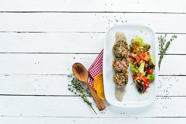 Baked veal medallions with sesame and vegetables. Dishes, food. Top view. Free space for your text. - Фото, изображение