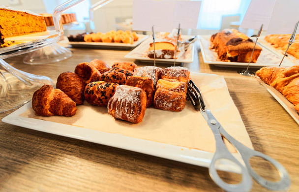 Sweet french pastry and croissants in cafe bakery - Foto, afbeelding