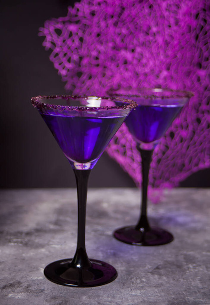 Two glasses with purple cocktail for Halloween party on the dark background - Valokuva, kuva
