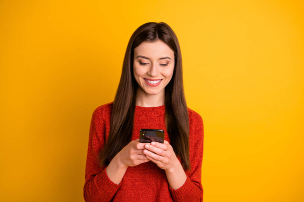 Photo of cheerful cute gorgeous attractive youngster holding telephone with hands smiling toothily browsing through multimedia isolated vivid color background - Φωτογραφία, εικόνα