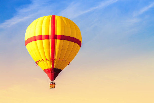 Yellow Flying Hot Air Balloon in the sky. - Zdjęcie, obraz