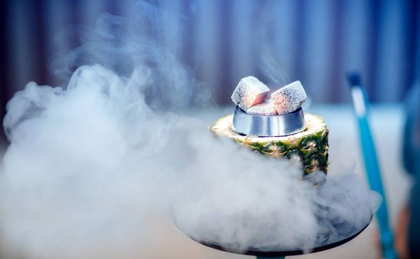 Hot coals hookah in pineapple bowl for smoking shisha traditional Turkish holiday - Valokuva, kuva